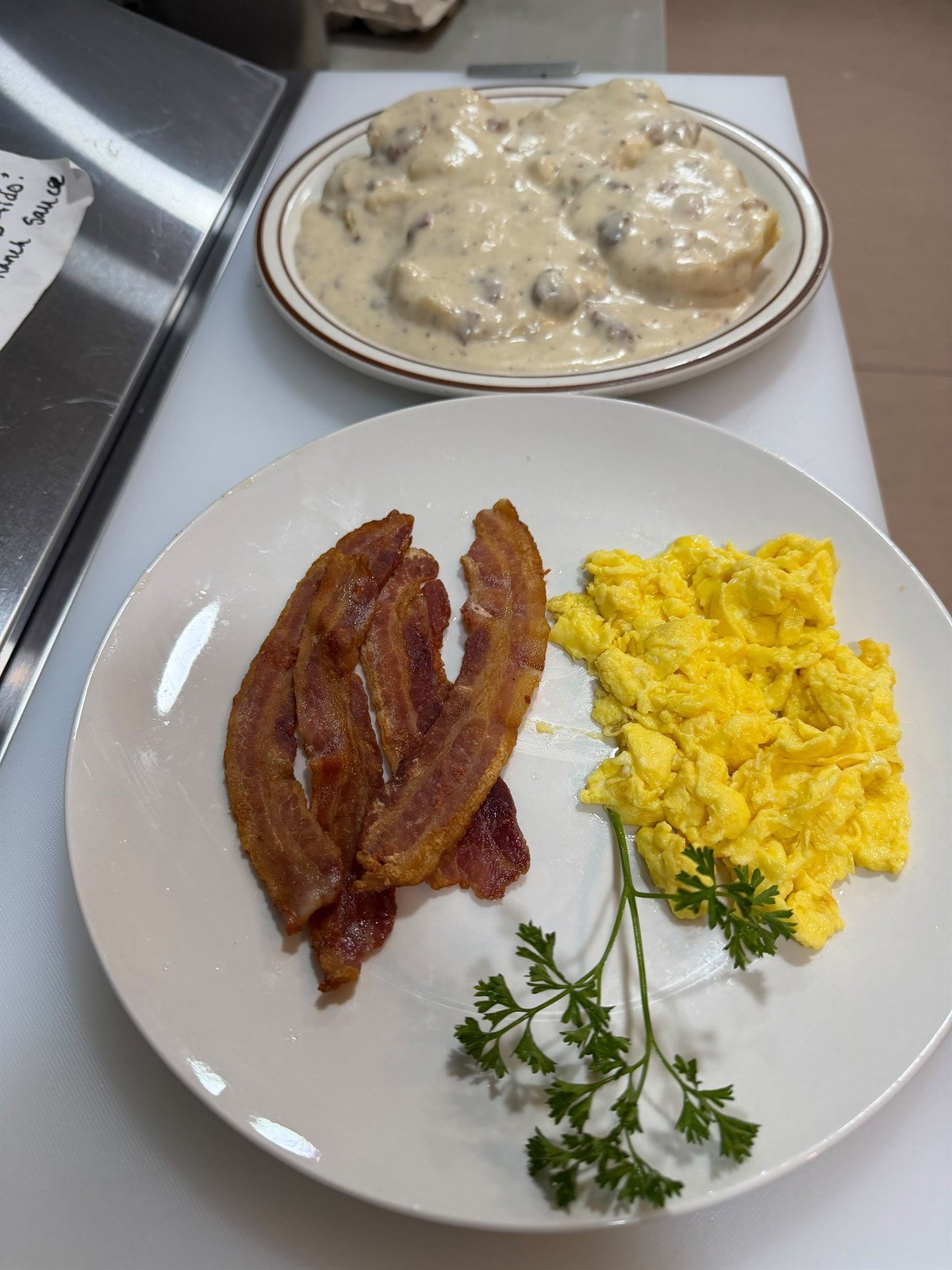 Bacon, scrambled eggs and biscuits with country gravy