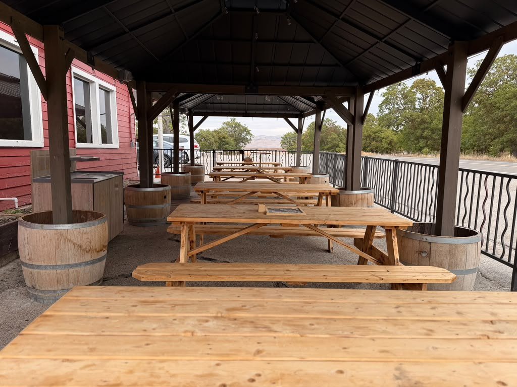 Picnic tables under the covered patio behind the cafe